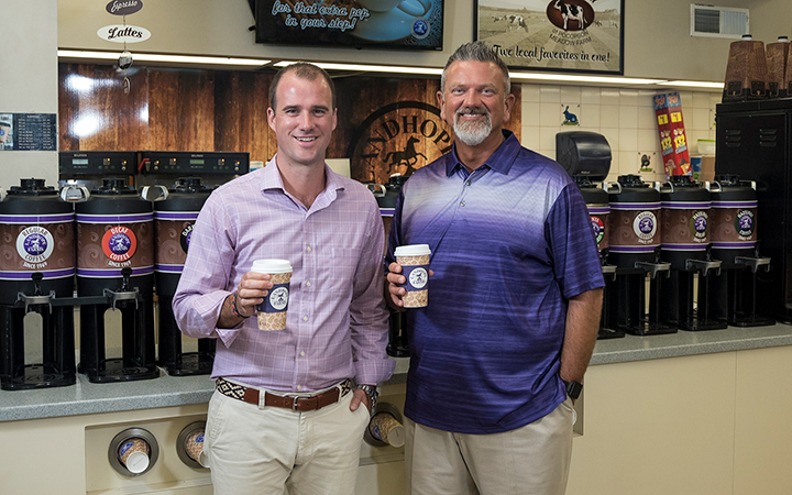 Photo of Landhope Farms' managers grabbing a cup of coffee.