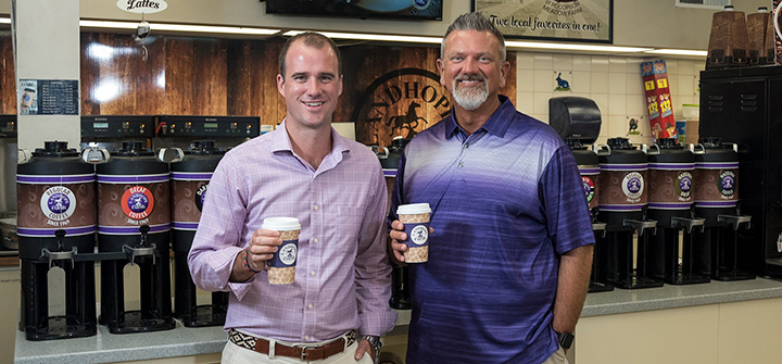 Photo of Landhope Farms' managers grabbing a cup of coffee.